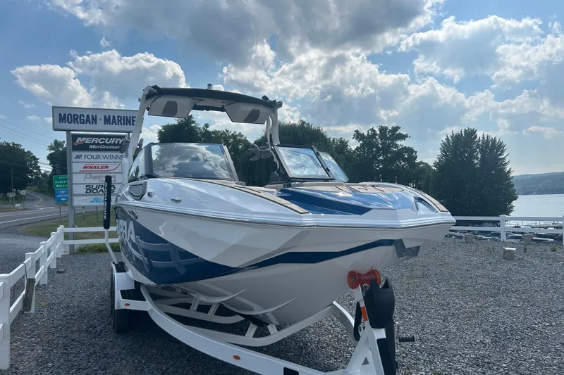 Slide: The Image of 2025 Supra SV boat at Morgan Marine dealership under a partly cloudy sky. - 4