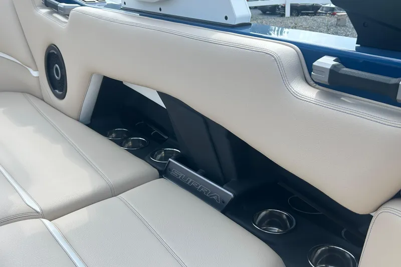 Slide: The Image of 2025 Supra SV interior with beige leather seats and integrated cup holders. - 43