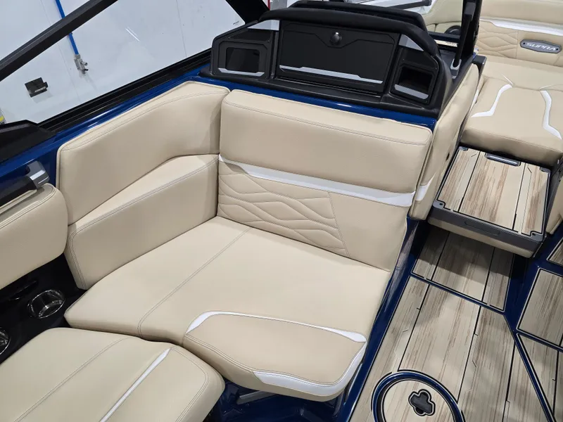 Slide: The Image of 2025 Supra SV boat interior with beige leather seating and wood flooring. - 44