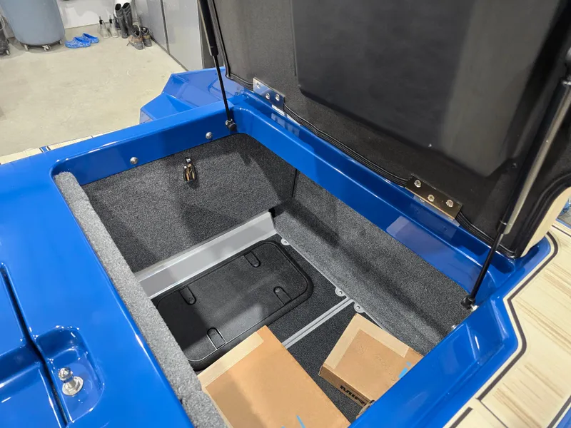 Slide: The Image of 2025 Supra SV trunk interior with blue exterior and storage compartments. - 49