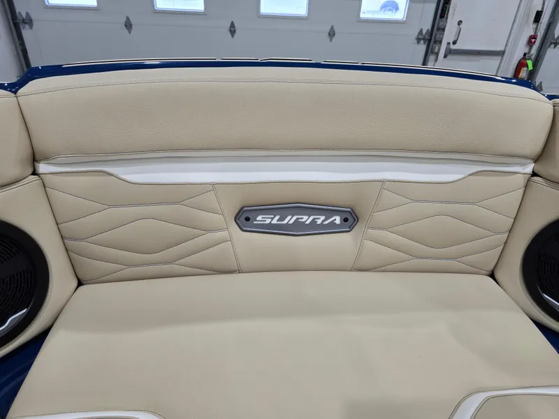 Slide: The Image of 2025 Supra SV interior with beige leather seats and branded emblem. - 51