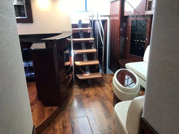 Slide: The Image of Interior of 2010 Sea Ray 610 Sundancer yacht with wooden flooring and modern seating. - 15