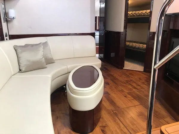 Slide: The Image of Luxurious interior of 2010 Sea Ray 610 Sundancer yacht with elegant seating and wooden flooring. - 16