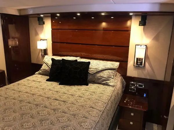 Slide: The Image of Luxurious bedroom interior of 2010 Sea Ray 610 Sundancer yacht with elegant bedding and lighting. - 23