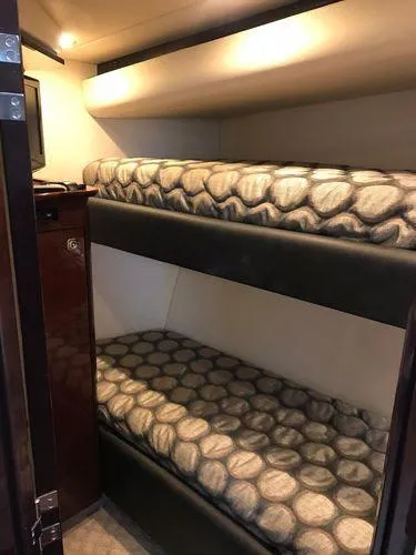 Slide: The Image of Bunk beds in 2010 Sea Ray 610 Sundancer yacht cabin, featuring patterned bedding. - 25