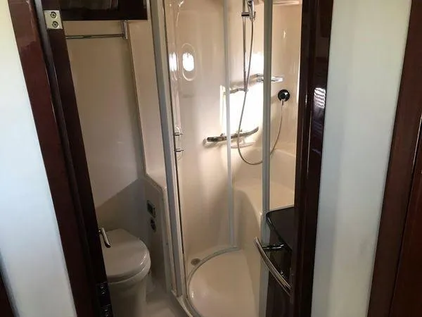 Slide: The Image of Luxurious bathroom in 2010 Sea Ray 610 Sundancer yacht, featuring shower and toilet. - 26