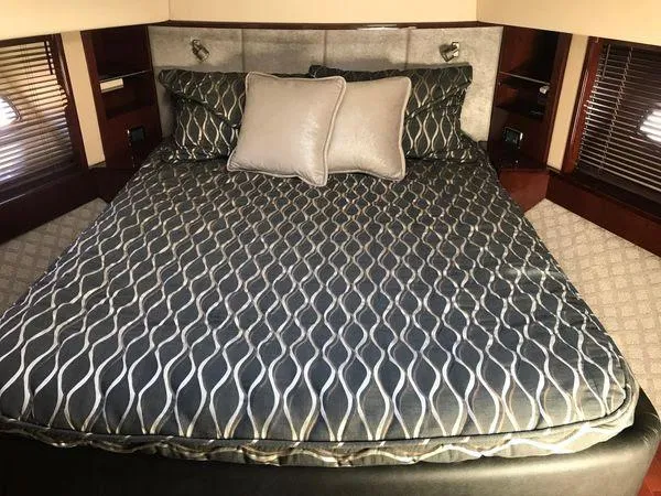 Slide: The Image of Luxurious bedroom interior of 2010 Sea Ray 610 Sundancer yacht with patterned bedding. - 27
