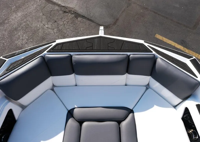 Slide: The Image of 2025 Moomba Max boat interior with gray and white cushioned seating. - 15