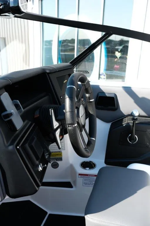 Slide: The Image of 2025 Moomba Max boat interior with steering wheel and control panel. - 18