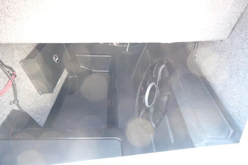 Slide: The Image of 2025 Moomba Max interior storage compartment with audio equipment. - 21