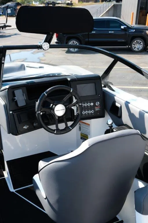 Slide: The Image of 2025 Moomba Max boat interior with steering wheel and control panel. - 9