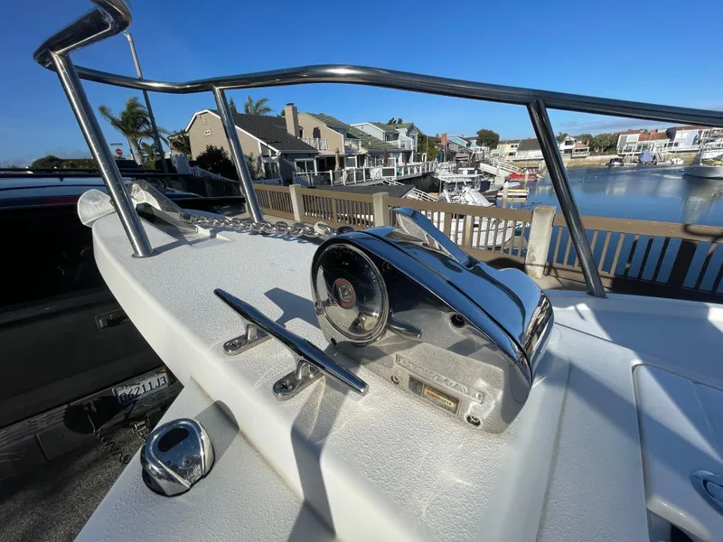 Slide: The Image of 2020 Parker 2320 Sport Cabin boat helm with waterfront view. - 16