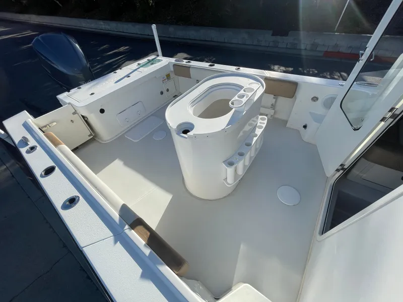 Slide: The Image of 2020 Parker 2320 Sport Cabin boat interior with seating and storage compartments. - 17