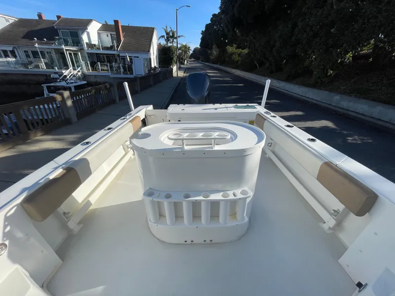 Slide: The Image of 2020 Parker 2320 Sport Cabin boat on a trailer, parked on a residential street. - 19