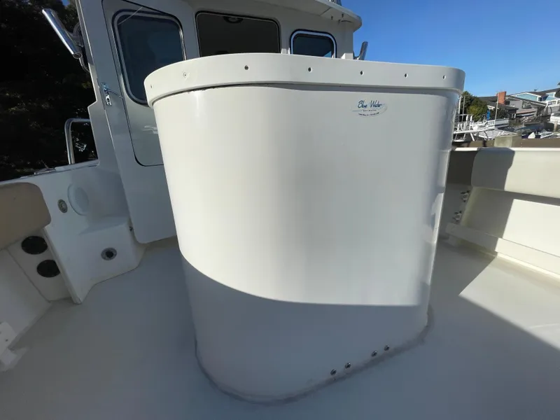 Slide: The Image of 2020 Parker 2320 Sport Cabin boat deck with white structure, sunny day. - 21