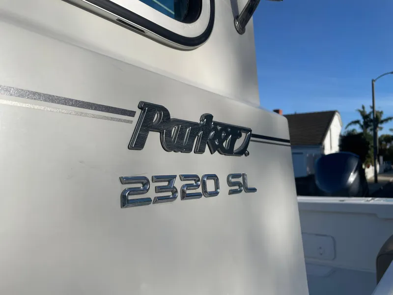 Slide: The Image of 2020 Parker 2320 Sport Cabin boat exterior with logo and model details. - 31