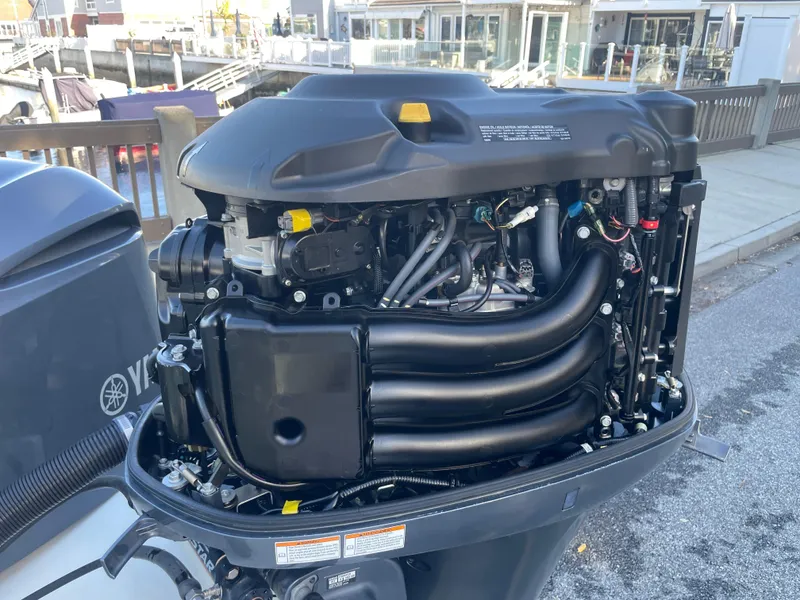 Slide: The Image of Open Yamaha outboard engine on a 2020 Parker 2320 Sport Cabin boat. - 34