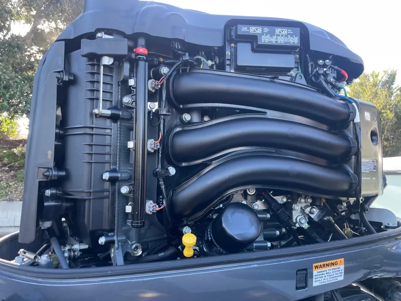 Slide: The Image of Close-up of a 2020 Parker 2320 Sport Cabin engine, showcasing intricate mechanical components. - 37