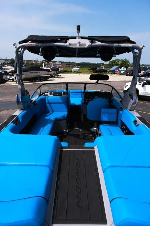 Slide: The Image of 2025 Moomba Max boat with vibrant blue seating and sleek design. - 10