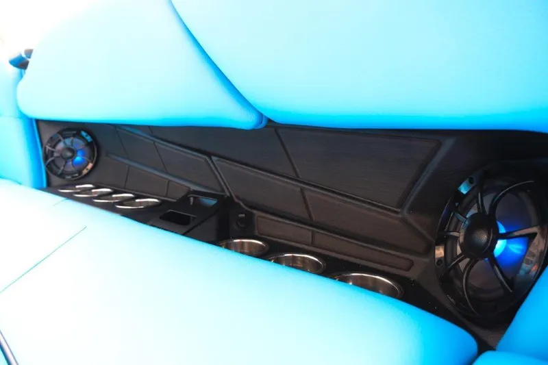 Slide: The Image of 2025 Moomba Max interior with blue seating, cup holders, and speakers. - 16