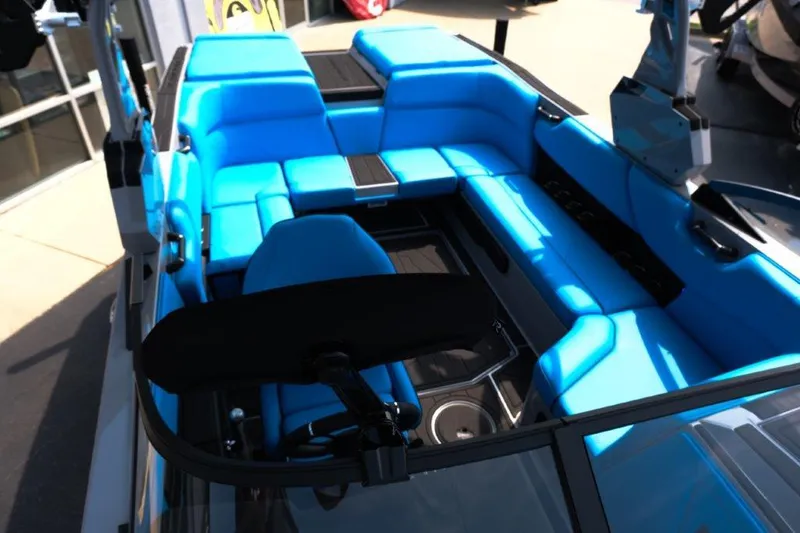 Slide: The Image of 2025 Moomba Max boat interior with vibrant blue seating and sleek design. - 19