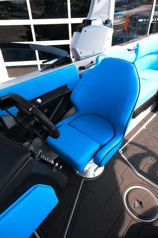 Slide: The Image of 2025 Moomba Max boat interior with blue seating and modern steering console. - 22