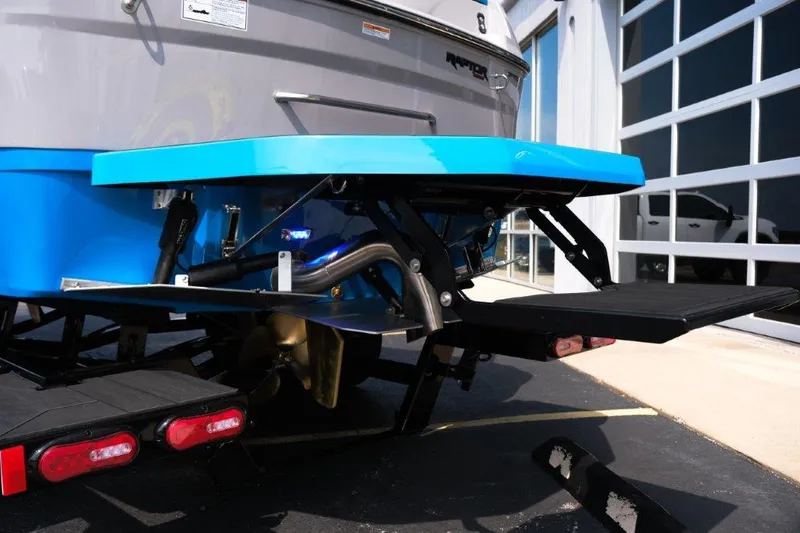 Slide: The Image of 2025 Moomba Max boat rear view with blue platform and trailer. - 4