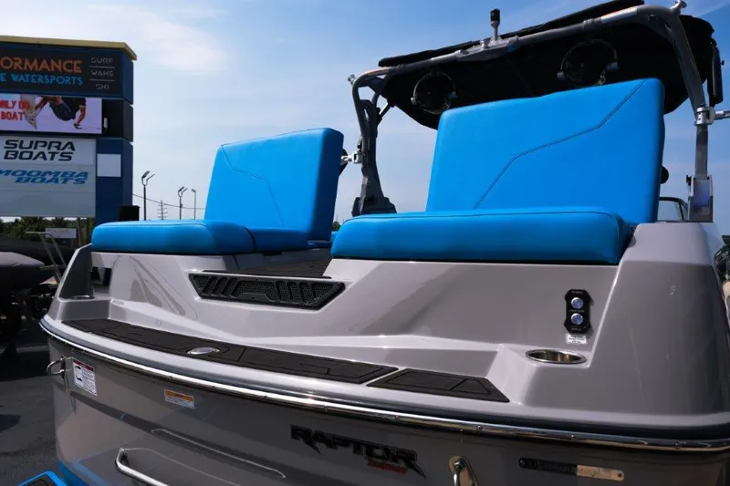 Slide: The Image of 2025 Moomba Max boat with blue seats and Raptor engine at dealership. - 5