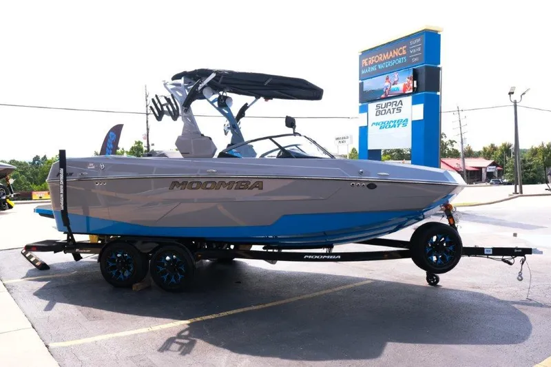 Slide: The Image of 2025 Moomba Max boat on trailer at dealership parking lot. - 6