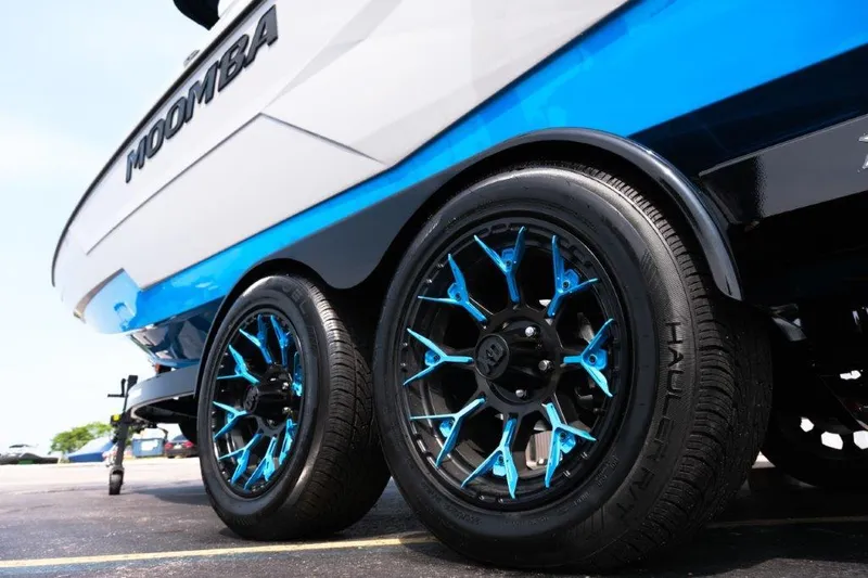Slide: The Image of 2025 Moomba Max boat trailer with stylish blue-accented wheels. - 7