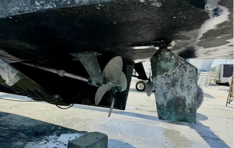 Slide: The Image of 1999 Mainship 350 Trawler underside showing propeller and rudder in dry dock. - 84