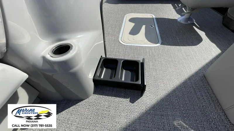 Slide: The Image of 2025 Barletta Aria A24UC boat interior with cup holders and carpeted flooring. - 15