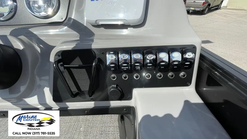 Slide: The Image of Control panel of 2025 Barletta Aria A24UC boat with various switches and gauges. - 19