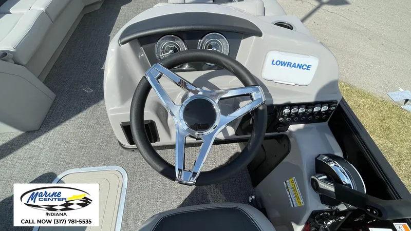 Slide: The Image of 2025 Barletta Aria A24UC boat dashboard with steering wheel and control panel. - 21