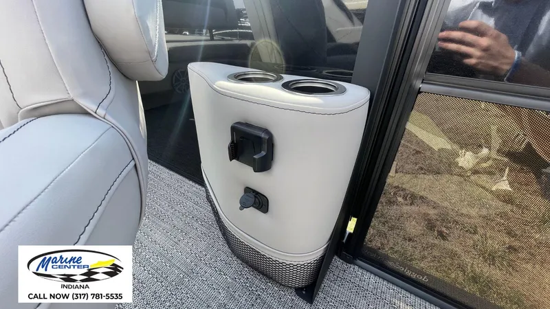 Slide: The Image of 2025 Barletta Aria A24UC interior with cup holders and charging ports. - 22