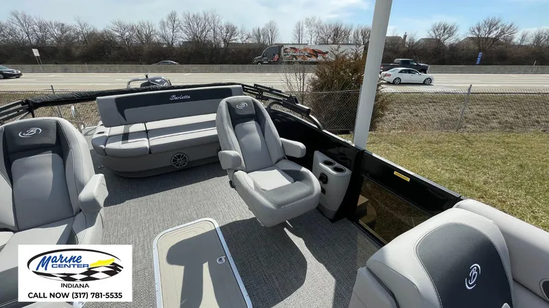 Slide: The Image of 2025 Barletta Aria A24UC pontoon boat interior with gray seating, displayed at Marine Center Indiana. - 25