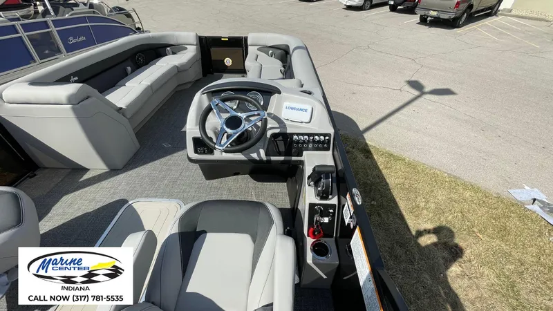 Slide: The Image of 2025 Barletta Aria A24UC pontoon boat interior with steering wheel and seating. - 5