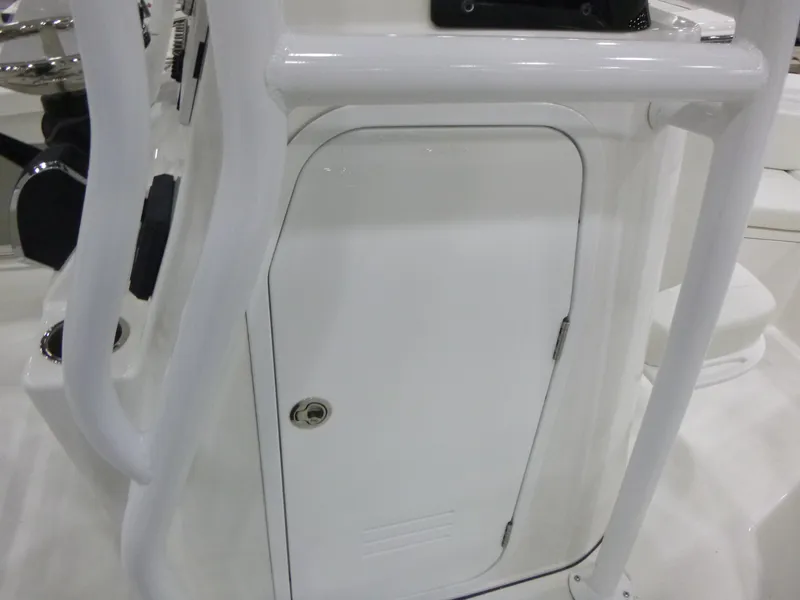 Slide: The Image of 2025 Sea Pro 225 Sandbar boat console with white storage compartment and railing. - 16