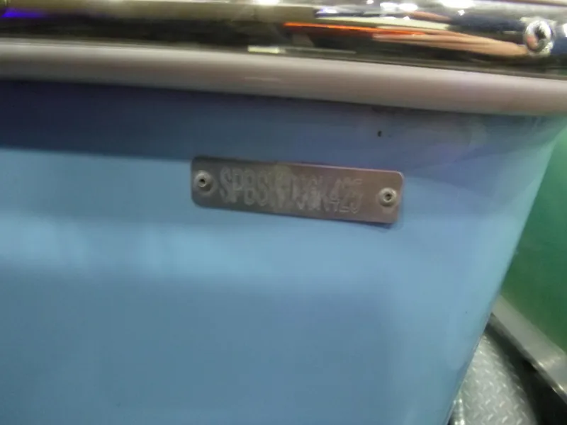 Slide: The Image of 2025 Sea Pro 225 Sandbar boat with identification plate on blue hull. - 20