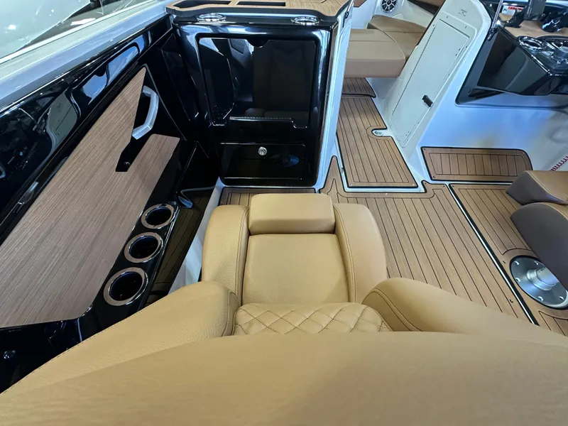 Slide: The Image of 2024 Yamaha 222SD jet boat interior with tan seating and wood-style flooring. - 11