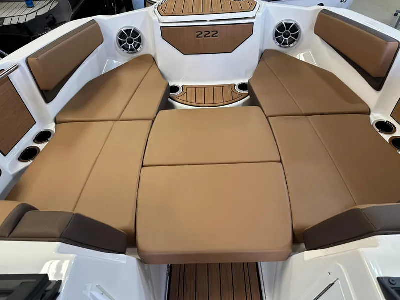 Slide: The Image of 2024 Yamaha 222SD jet boat interior with tan seating and cup holders. - 13