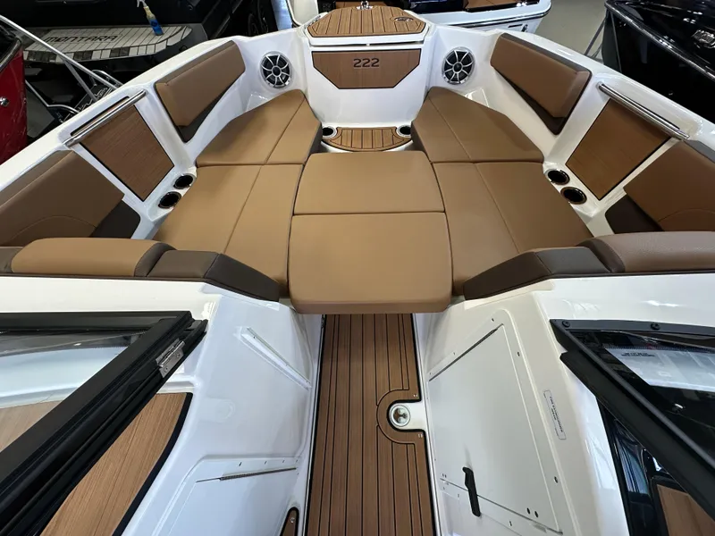 Slide: The Image of 2024 Yamaha 222SD jet boat interior with brown seating and wood accents. - 14