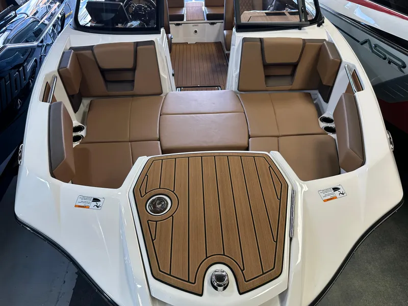 Slide: The Image of 2024 Yamaha 222SD jet boat interior with tan seating and wood accents. - 16