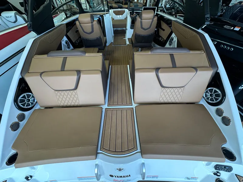 Slide: The Image of 2024 Yamaha 222SD jet boat interior with tan seating and wood accents. - 2