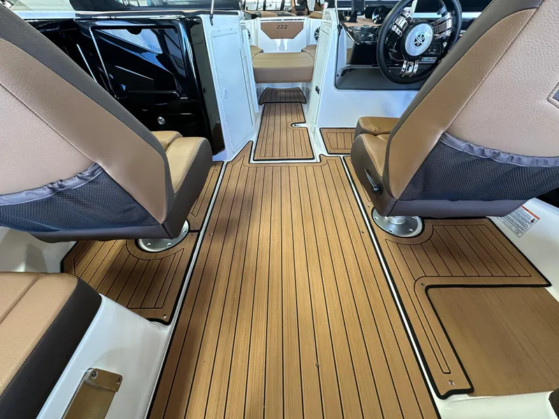 Slide: The Image of 2024 Yamaha 222SD jet boat interior with brown seats and wood-style flooring. - 4