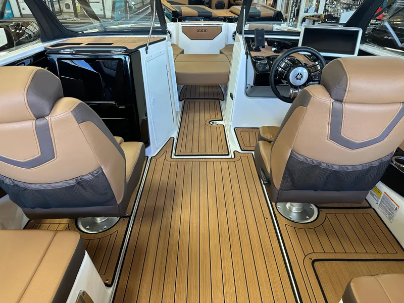 Slide: The Image of 2024 Yamaha 222SD jet boat interior with tan seats and wood-style flooring. - 5
