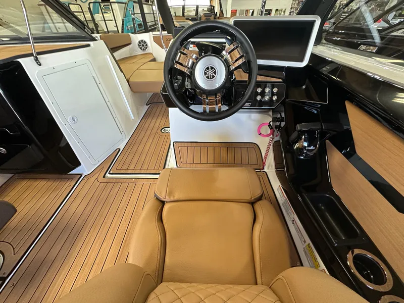 Slide: The Image of 2024 Yamaha 222SD jet boat interior with steering wheel and tan seating. - 6