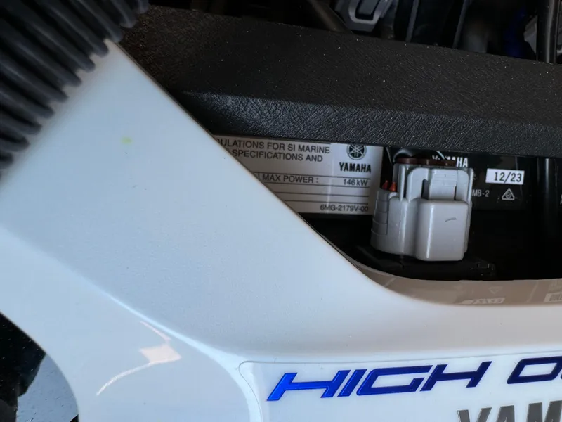 Slide: The Image of Close-up of 2024 Yamaha 222SD jet boat engine label and components. - 11