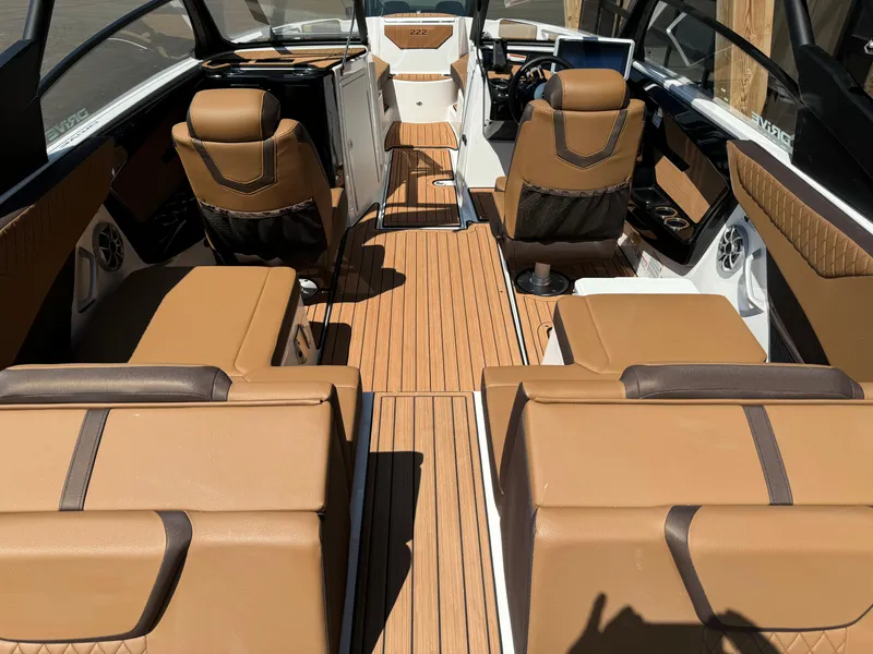 Slide: The Image of 2024 Yamaha 222SD jet boat interior with tan leather seating and wood-style flooring. - 12