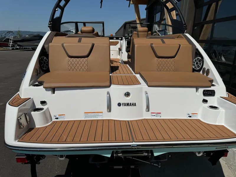 Slide: The Image of 2024 Yamaha 222SD jet boat with tan seating and teak-style deck. - 13